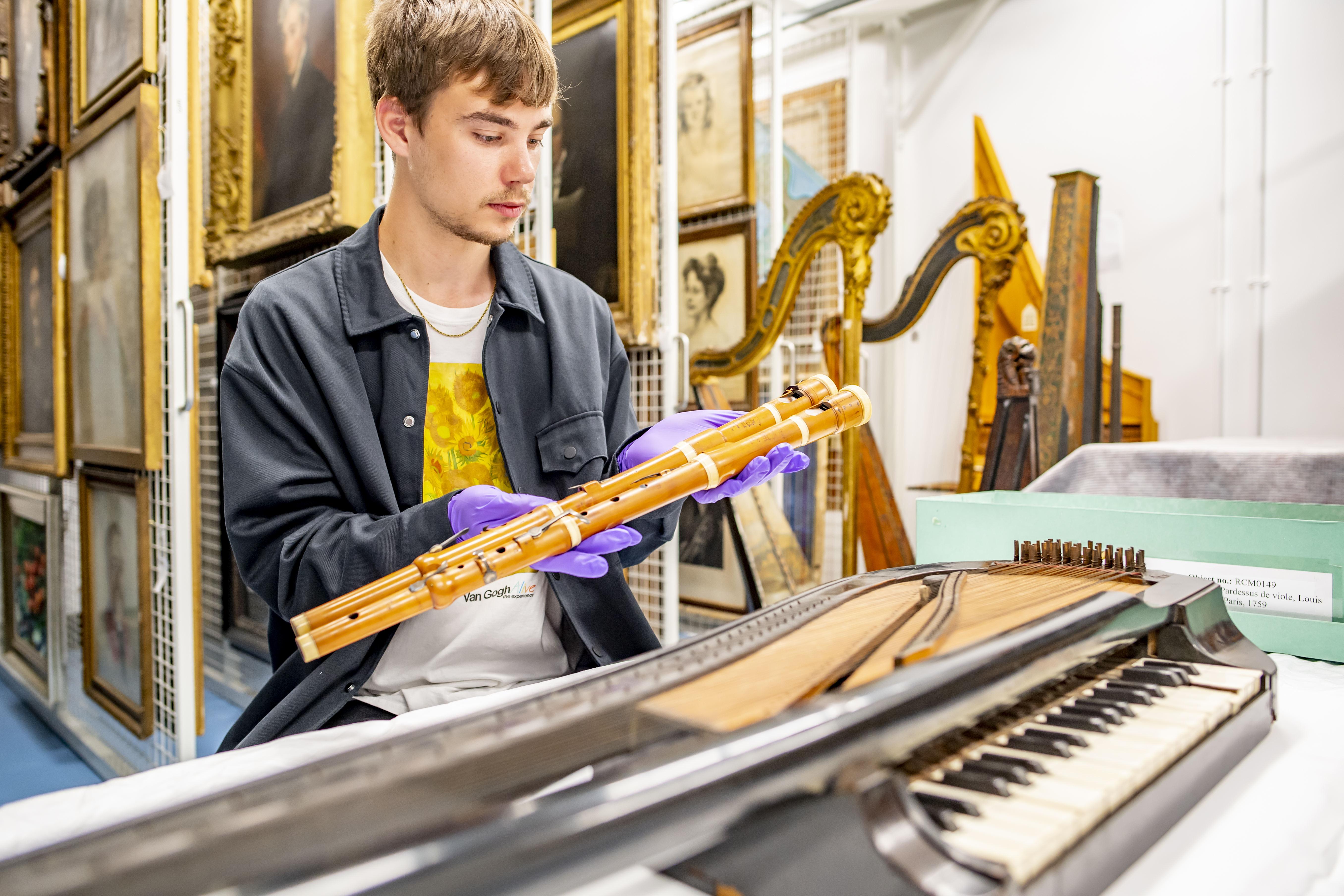 Man inspecting historical flute in Wolfson Centre